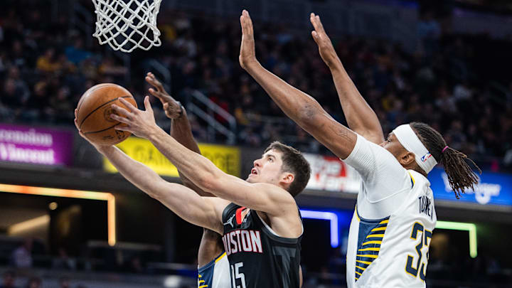 Mar 4, 2025; Indianapolis, Indiana, USA; Houston Rockets guard Reed Sheppard (15) shoots the ball while Indiana Pacers center Myles Turner (33) defends in the first half at Gainbridge Fieldhouse. Mandatory Credit: Trevor Ruszkowski-Imagn Images