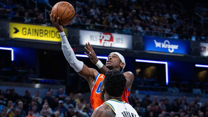 Dec 26, 2024; Indianapolis, Indiana, USA; Oklahoma City Thunder guard Shai Gilgeous-Alexander (2) shoots the ball while Indiana Pacers center Thomas Bryant (3) defends in the second half at Gainbridge Fieldhouse. Mandatory Credit: Trevor Ruszkowski-Imagn Images