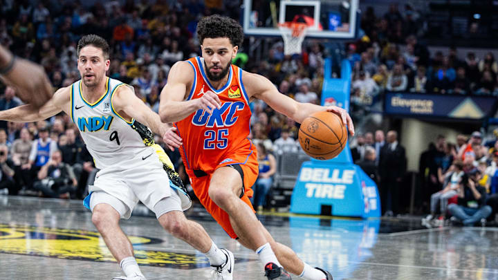 Dec 26, 2024; Indianapolis, Indiana, USA; Oklahoma City Thunder guard Ajay Mitchell (25) dribbles the ball while Indiana Pacers guard T.J. McConnell (9) defends in the second half at Gainbridge Fieldhouse. Mandatory Credit: Trevor Ruszkowski-Imagn Images