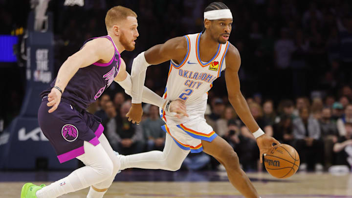 Dec 19, 2025; Minneapolis, Minnesota, USA; Oklahoma City Thunder guard Shai Gilgeous-Alexander (2) works past Minnesota Timberwolves guard Donte DiVincenzo (0) in the first quarter at Target Center. Mandatory Credit: Bruce Kluckhohn-Imagn Images
