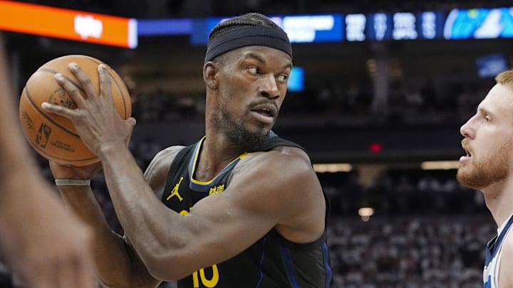 Minnesota Timberwolves guard Donte DiVincenzo (0) defends against Golden State Warriors forward Jimmy Butler (10) in the fourth quarter during game one of the second round for the 2025 NBA Playoffs at Target Center. Mandatory Credit: Bruce Kluckhohn-Imagn Images