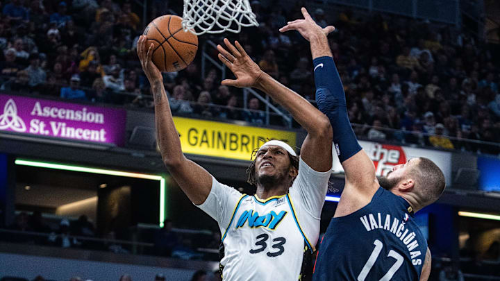 Nov 24, 2024; Indianapolis, Indiana, USA; Indiana Pacers center Myles Turner (33) shoots the ball while Washington Wizards center Jonas Valanciunas (17) defends in the first half at Gainbridge Fieldhouse. Mandatory Credit: Trevor Ruszkowski-Imagn Images
