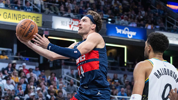 Nov 24, 2024; Indianapolis, Indiana, USA; Washington Wizards forward Corey Kispert (24) shoots the ball while  Indiana Pacers guard Tyrese Haliburton (0) defends in the second half at Gainbridge Fieldhouse. Mandatory Credit: Trevor Ruszkowski-Imagn Images