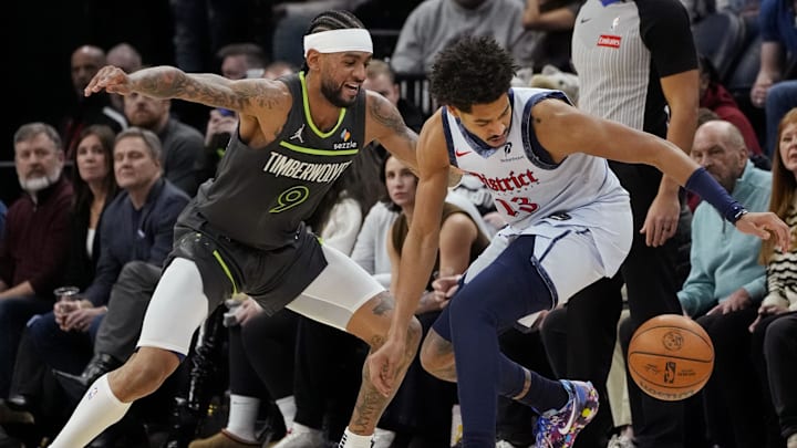Feb 1, 2025; Minneapolis, Minnesota, USA; Minnesota Timberwolves forward Nickeil Alexander-Walker (9) challenges Washington Wizards guard Jordan Poole (13) for the ball in the fourth quarter at Target Center. Mandatory Credit: Bruce Kluckhohn-Imagn Images