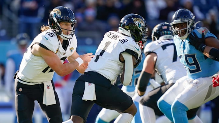 Jacksonville Jaguars quarterback Trevor Lawrence (16) hands off to running back Travis Etienne Jr. (1) during the third quarter against the Tennessee Titans at Nissan Stadium in Nashville, Tenn., Sunday, Nov. 30, 2025.