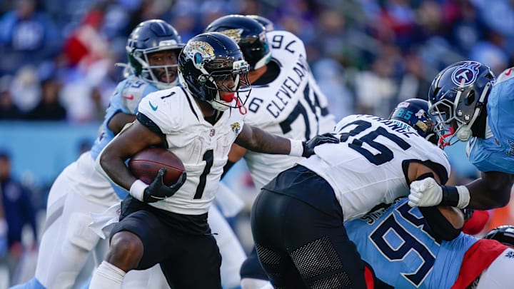 Jacksonville Jaguars running back Travis Etienne Jr. (1) runs the ball during the third quarter against the Tennessee Titans at Nissan Stadium in Nashville, Tenn., Sunday, Nov. 30, 2025.