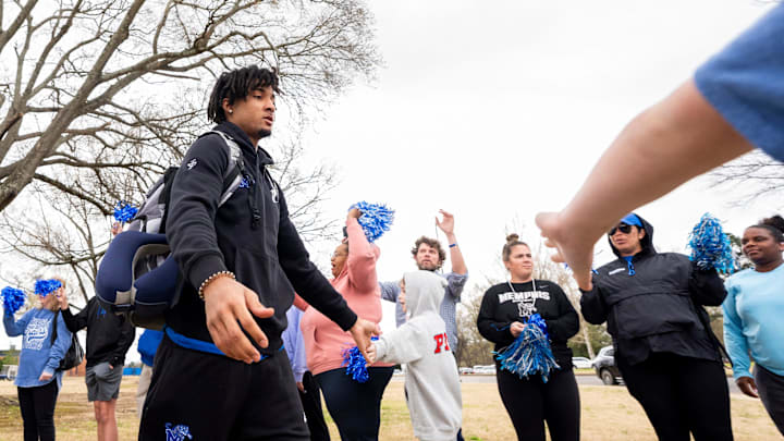 Memphis’ PJ Haggerty high fives fans as they cheer on the Memphis men’s basketball team as they head to the bus to leave for Seattle for the first round of March Madness from the Laurie-Walton Basketball Center in Memphis, Tenn., on Wednesday, March 19. 2025.