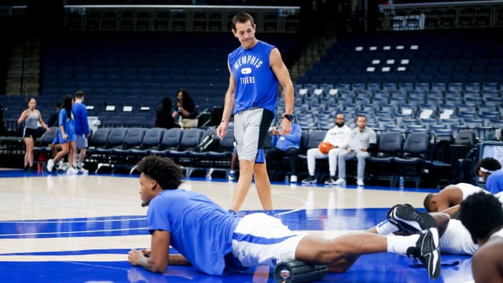 Darby Rich, the Memphis strength and conditioning coach, leads the men   s basketball team in stretching before the preseason game against Lane College at FedExForum in Memphis, Tenn., on Sunday, October 29, 2023.