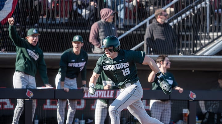 Michigan State catcher Adam Broski scores the go-ahead run in the eighth inning against the Louisville Cardinals.
