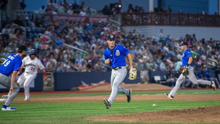 The Blue Wahoos load the bases as Biloxi Shuckers third baseman Brock Wilken (25) can't find the handle on a soft grounder during the opening night of the baseball season in Pensacola on Friday, April 4, 2025.
