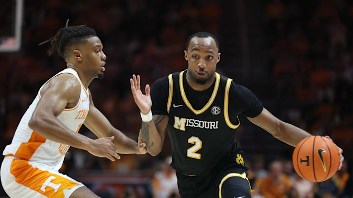 Feb 5, 2025; Knoxville, Tennessee, USA; Missouri Tigers guard Tamar Bates (2) moves the ball against Tennessee Volunteers guard Chaz Lanier (2) during the second half at Thompson-Boling Arena at Food City Center. Mandatory Credit: Randy Sartin-Imagn Images