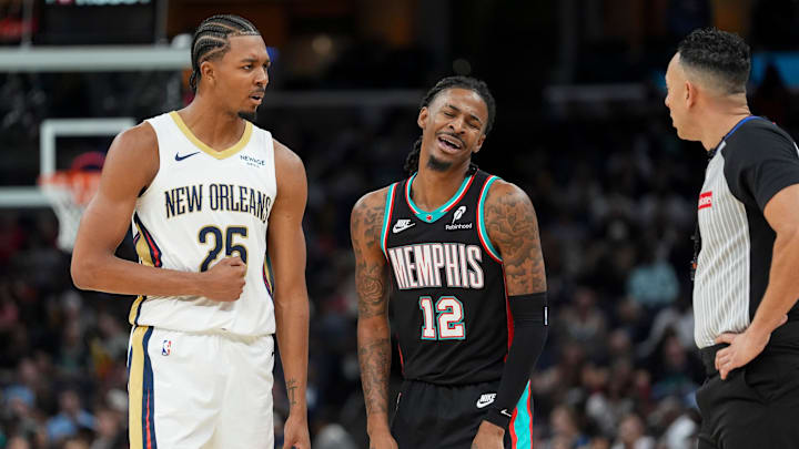 Pelicans' Trey Murphy III (25) and Grizzlies' Ja Morant (12) disagree over a foul call during the home opener against the New Orleans Pelicans at FedExForum on October 22, 2025. Pelicans' Trey Murphy III (25) and Grizzlies' Ja Morant (12) disagree over a foul call during the home opener against the New Orleans Pelicans at FedExForum on October 22, 2025.