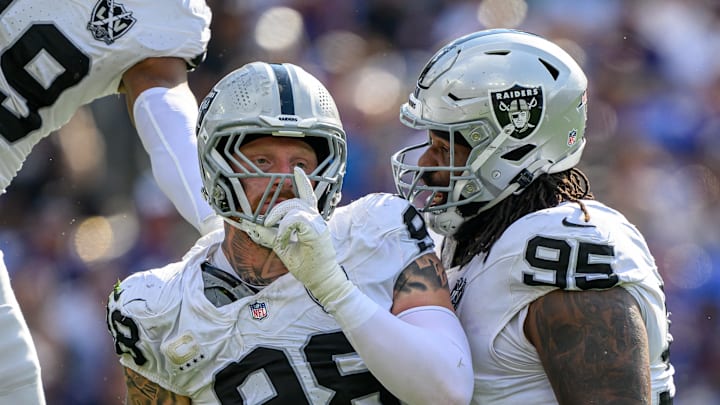 Sep 15, 2024; Baltimore, Maryland, USA; Las Vegas Raiders defensive end Maxx Crosby (98) celebrates with defensive tackle John Jenkins (95) after sacking Baltimore Ravens quarterback Lamar Jackson (not pictured) during the second half at M&T Bank Stadium. Mandatory Credit: Reggie Hildred-Imagn Images