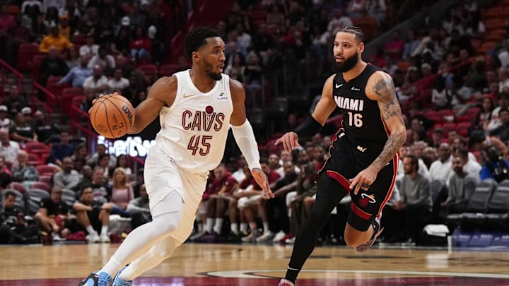 Dec 8, 2023; Miami, Florida, USA; Cleveland Cavaliers guard Donovan Mitchell (45) drives the ball around Miami Heat forward Caleb Martin (16) during the second half at Kaseya Center. Mandatory Credit: Jasen Vinlove-USA TODAY Sports