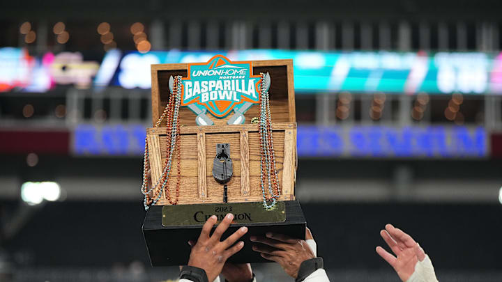 Georgia Tech Yellow lifts the trophy after they won the 2023 Gasparilla Bowl at Raymond James Stadium. 