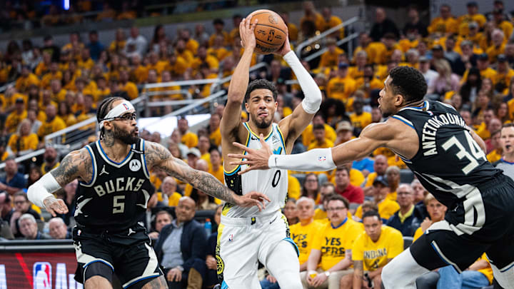 Indiana Pacers guard Tyrese Haliburton shoots over Bucks guard Gary Trent Jr. and forward Giannis Antetokounmpo.