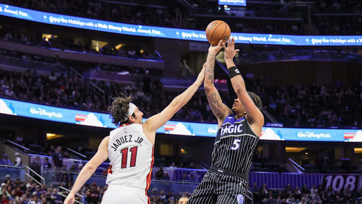 Dec 9, 2025; Orlando, Florida, USA; Orlando Magic forward Paolo Banchero (5) shoots against Miami Heat forward Jaime Jaquez Jr. (11) during the second half at Kia Center. Mandatory Credit: Mike Watters-Imagn Images