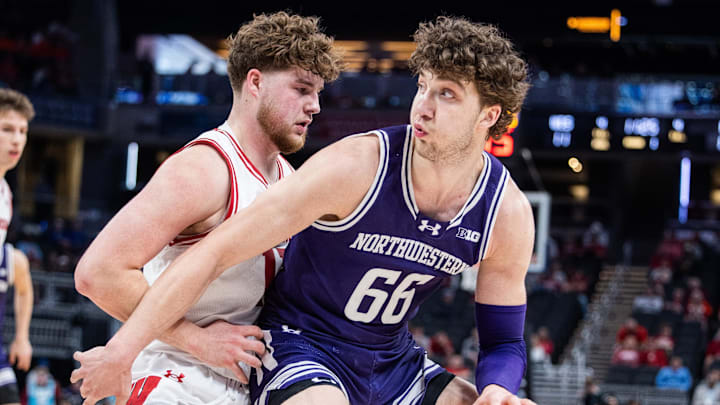 Mar 13, 2025; Indianapolis, IN, USA; Northwestern Wildcats forward Nick Martinelli (2) dribbles the ball while Wisconsin Badgers guard Max Klesmit (11) defends in the first half at Gainbridge Fieldhouse. Mandatory Credit: Trevor Ruszkowski-Imagn Images