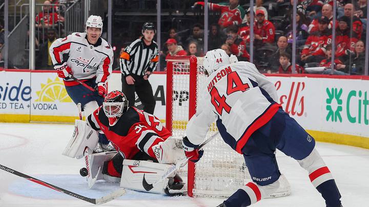 Apr 2, 2026; Newark, New Jersey, USA; New Jersey Devils goaltender Jake Allen (34) makes a save on Washington Capitals defenseman Cole Hutson (44) during the third period at Prudential Center. Mandatory Credit: Ed Mulholland-Imagn Images