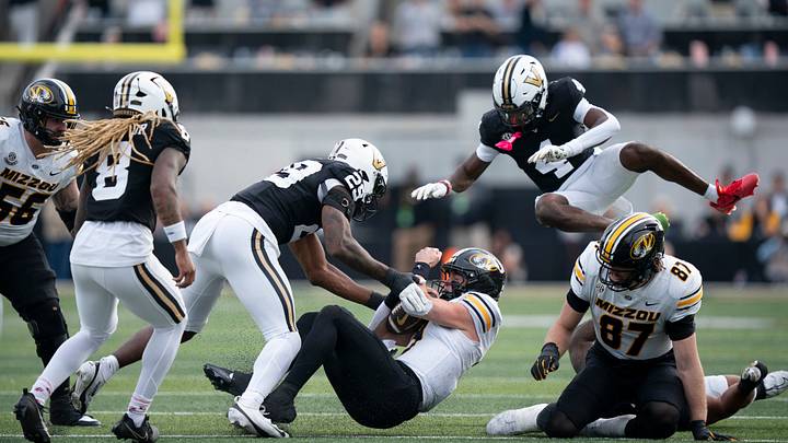 Missouri's quarterback Beau Pribula (9) is brought down after a short run by Vanderbilt's defensive end Miles Capers (29) during their game at FirstBank Stadium in Nashville, Tenn., Saturday, Oct. 25, 2025. Missouri's quarterback Beau Pribula (9) is brought down after a short run by Vanderbilt's defensive end Miles Capers (29) during their game at FirstBank Stadium in Nashville, Tenn., Saturday, Oct. 25, 2025.