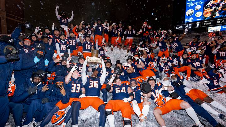 The 2025 Illinois football team celebrates its 20-13 win over Northwestern and securing The Hat award in the teams' rivalry last Nov. 29 at Memorial Stadium in Champaign, Illinois.