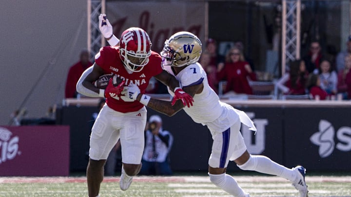Oct 26, 2024; Bloomington, Indiana, USA; Indiana Hoosiers wide receiver Miles Cross (19) is tackled by Washington Huskies cornerback Ephesians Prysock (7) during the second quarter at Memorial Stadium. Mandatory Credit: Jacob Musselman-Imagn Images