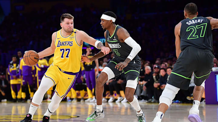 Apr 30, 2025; Los Angeles, California, USA; Los Angeles Lakers guard Luka Doncic (77) moves the ball against Minnesota Timberwolves forward Jaden McDaniels (3) during the first half in game five of first round for the 2025 NBA Playoffs at Crypto.com Arena. Mandatory Credit: Gary A. Vasquez-Imagn Images