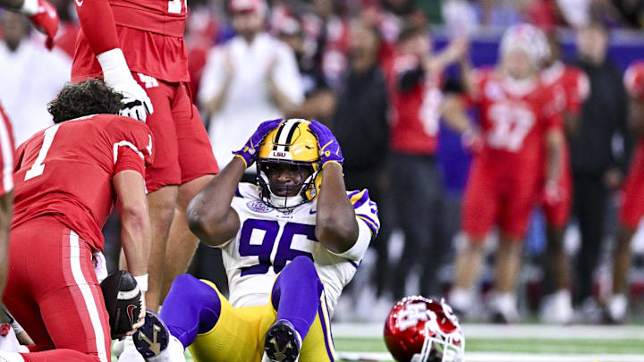Dec 27, 2025; Houston, TX, USA; Louisiana State Tigers defensive tackle Dominick McKinley (96) reacts after tackling Houston Cougars quarterback Conner Weigman (1) during the first half at NRG Stadium. Mandatory Credit: Maria Lysaker-Imagn Images 