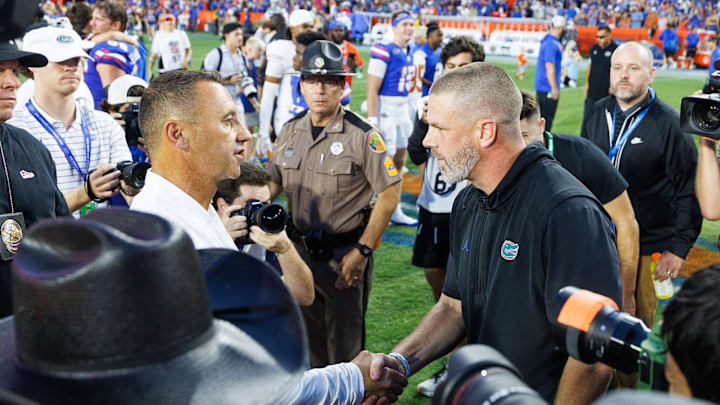Oct 4, 2025; Gainesville, Florida, USA; Texas Longhorns head coach Steve Sarkisian shakes hands with Florida Gators head coach Billy Napier during the second half at Ben Hill Griffin Stadium. Mandatory Credit: Matt Pendleton-Imagn Images