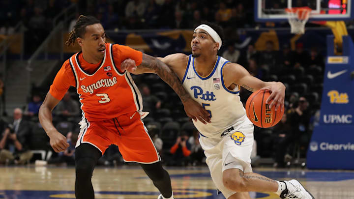 Feb 18, 2025; Pittsburgh, Pennsylvania, USA;  Pittsburgh Panthers guard Ishmael Leggett (5) drives against Syracuse Orange guard Lucas Taylor (3) during the first half at the Petersen Events Center. Mandatory Credit: Charles LeClaire-Imagn Images