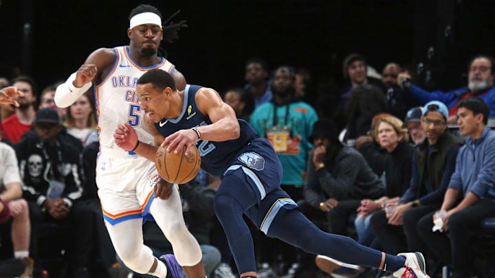 Mar 5, 2025; Memphis, Tennessee, USA; Memphis Grizzlies guard Desmond Bane (22) drives to the basket as Oklahoma City Thunder guard Luguentz Dort (5) defends during the first quarter at FedExForum. Mandatory Credit: Petre Thomas-Imagn Images
