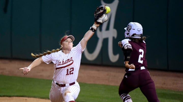 April 15, 2024; Tuscaloosa, AL, USA; Alabama utility player Emma Broadfoot (12) stretches out but can’t snag a high throw as Texas A&M batter Rylen Wiggins is safe at first at Rhoads Stadium Monday.