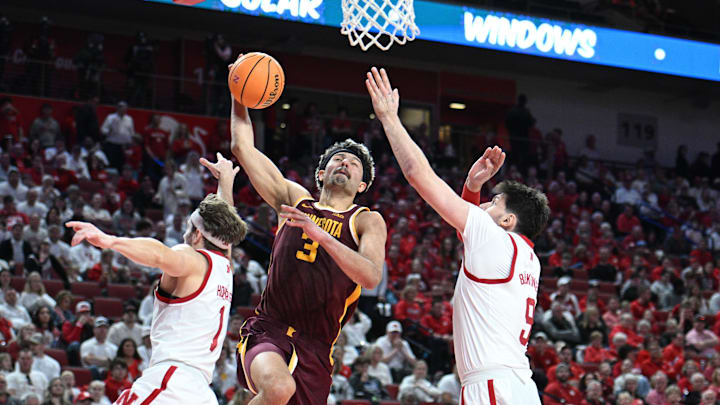 Mar 1, 2025; Lincoln, Nebraska, USA; Minnesota Golden Gophers forward Dawson Garcia (3) drives against Nebraska Cornhuskers guard Sam Hoiberg (1) and forward Berke Buyuktuncel (9) during the second half at Pinnacle Bank Arena. Mandatory Credit: Steven Branscombe-Imagn Images