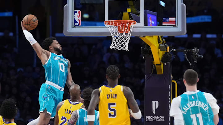 Jan 15, 2026; Los Angeles, California, USA; Charlotte Hornets forward Miles Bridges (0) dunks the ball against the Los Angeles Lakers in the first half at Crypto.com Arena. Mandatory Credit: Kirby Lee-Imagn Images
