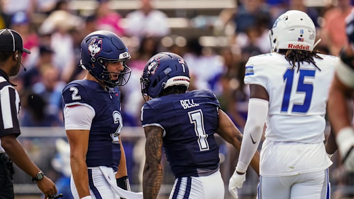Aug 30, 2025; East Hartford, Connecticut, USA; Connecticut Huskies wide receiver Skyler Bell (1) reacts with quarterback Joe Fagnano (2) after his touchdown against the Central Connecticut State Blue Devils in the first half at Pratt & Whitney Stadium at Rentschler Field. Mandatory Credit: David Butler II-Imagn Images