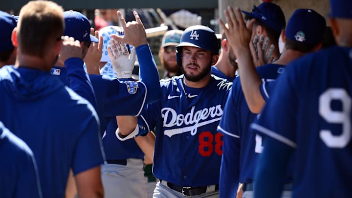 Feb 29, 2020; Salt River Pima-Maricopa, Arizona, USA; Los Angeles Dodgers left fielder Zach Reks (88) high fives teammates in the dugout after hitting a solo home run against the Colorado Rockies during the second inning of a spring training game at Salt River Fields at Talking Stick. Mandatory Credit: Joe Camporeale-Imagn Images Feb 29, 2020; Salt River Pima-Maricopa, Arizona, USA; Los Angeles Dodgers left fielder Zach Reks (88) high fives teammates in the dugout after hitting a solo home run against the Colorado Rockies during the second inning of a spring training game at Salt River Fields at Talking Stick. Mandatory Credit: Joe Camporeale-Imagn Images