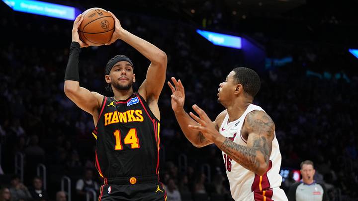 Apr 12, 2026; Miami, Florida, USA;  Atlanta Hawks forward Asa Newell (14) looks to pass against Miami Heat forward Keshad Johnson (16) during the first half at Kaseya Center. Mandatory Credit: Jim Rassol-Imagn Images