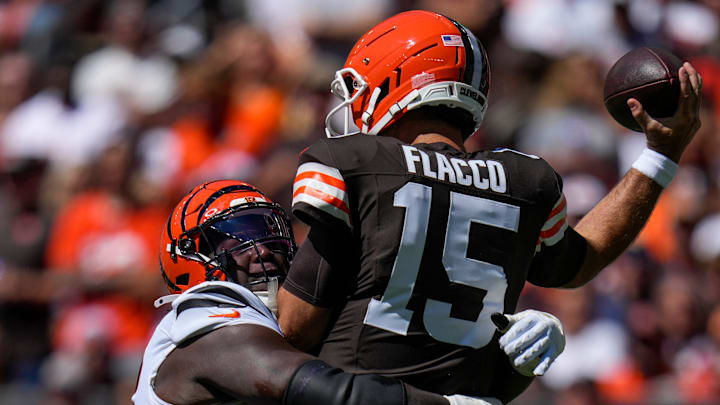 Cincinnati Bengals defensive tackle T.J. Slaton Jr. (98) wraps up Cleveland Browns quarterback Joe Flacco (15) as he throws in the second quarter of the NFL Week 1 game between the Cleveland Browns and the Cincinnati Bengals at Huntington Bank Field in Cleveland on Sunday, Sept. 7, 2025.