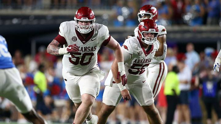 Sep 13, 2025; Oxford, Mississippi, USA; Arkansas Razorback offensive lineman Kobe Branham (50) and offensive lineman Caden Kitler (52) block during the fourth quarter against the Mississippi Rebels at Vaught-Hemingway Stadium. Mandatory Credit: Petre Thomas-Imagn Images