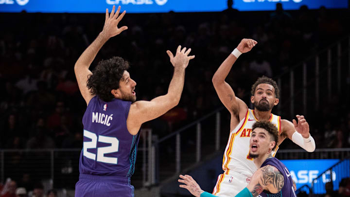 Oct 25, 2024; Atlanta, Georgia, USA; Atlanta Hawks guard Trae Young (11) makes a pass against Charlotte Hornets guard Vasilije Micic (22) and guard LaMelo Ball (1) during the fourth quarter at State Farm Arena. Mandatory Credit: Jordan Godfree-Imagn Images Oct 25, 2024; Atlanta, Georgia, USA; Atlanta Hawks guard Trae Young (11) makes a pass against Charlotte Hornets guard Vasilije Micic (22) and guard LaMelo Ball (1) during the fourth quarter at State Farm Arena. Mandatory Credit: Jordan Godfree-Imagn Images