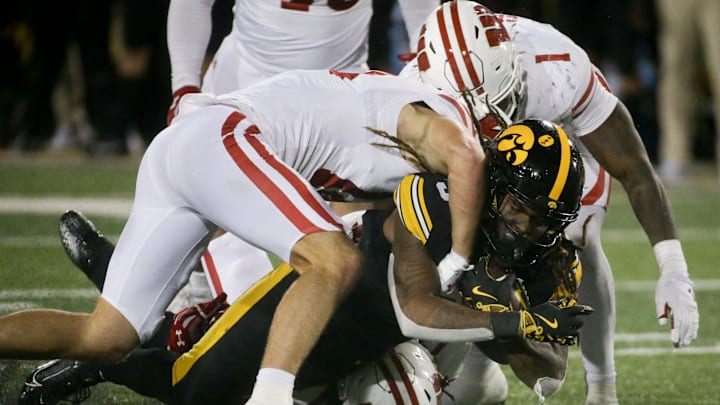 The Wisconsin Badgers defense tackles Iowa running back Jaziun Patterson (9) Saturday, Nov. 2, 2024 at Kinnick Stadium in Iowa City, Iowa.