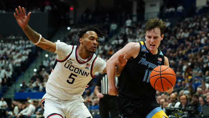 Feb 17, 2024; Hartford, Connecticut, USA; Marquette Golden Eagles guard Tyler Kolek (11) drives the ball against UConn Huskies guard Stephon Castle (5) in the first half at XL Center. Mandatory Credit: David Butler II-USA TODAY Sports