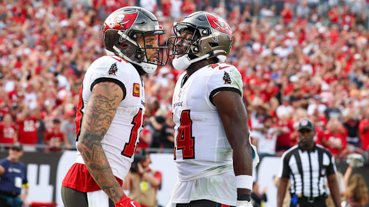 Jan 1, 2023; Tampa, Florida, USA; Tampa Bay Buccaneers wide receiver Chris Godwin (14) congratulates wide receiver Mike Evans (13) after scoring a touchdown against the Carolina Panthers in the fourth quarter at Raymond James Stadium. Jan 1, 2023; Tampa, Florida, USA; Tampa Bay Buccaneers wide receiver Chris Godwin (14) congratulates wide receiver Mike Evans (13) after scoring a touchdown against the Carolina Panthers in the fourth quarter at Raymond James Stadium.