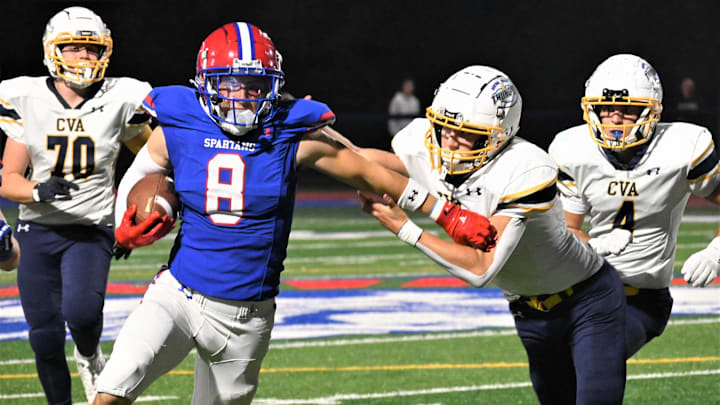 Spartans senior receiver Peyton Way (8) fends off Central Valley Academy tackler Cal Jacquays on a punt return on Sept. 26, 2025, at Don Edick Field in New Hartford.