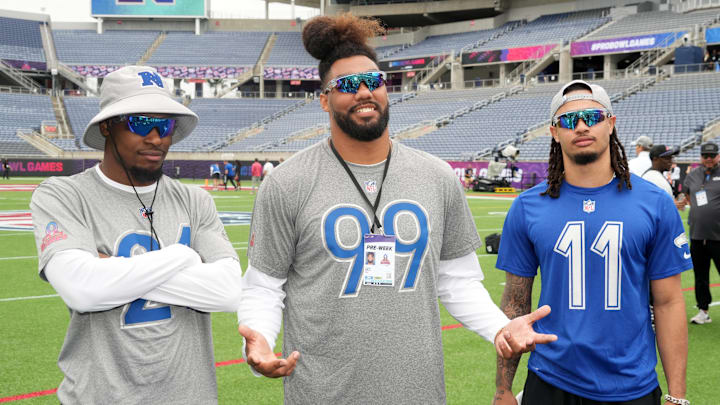 Feb 1, 2025; Orlando, FL, USA; Seattle Seahawks cornerback Devon Witherspoon (21), defensive end Leonard Williams (99) and receiver Jason Smith-Njigban (11) pose during NFC Practice for the Pro Bowl Games at Camping World Stadium. 
