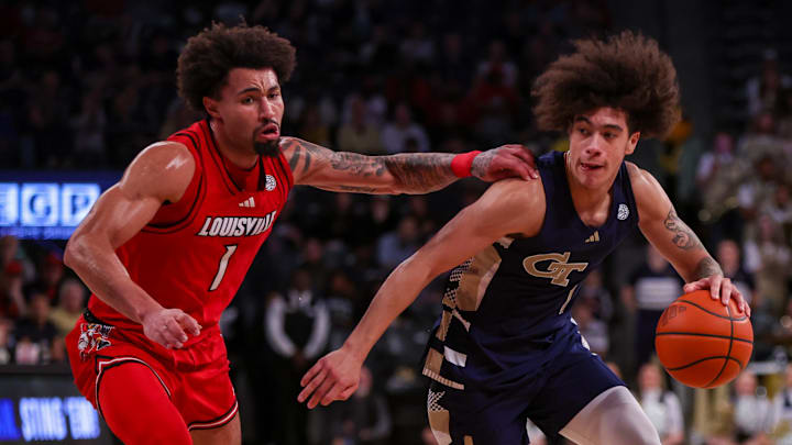 Feb 1, 2025; Atlanta, Georgia, USA; Georgia Tech Yellow Jackets guard Naithan George (1) drives on Louisville Cardinals guard J'Vonne Hadley (1) in the second half at McCamish Pavilion. Mandatory Credit: Brett Davis-Imagn Images
