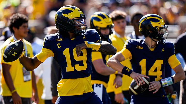 Michigan quarterback Bryce Underwood (19) and quarterback Tommy Carr (14) warm up ahead of the game between Michigan and Iowa at Michigan Stadium in Ann Arbor on Saturday, Sept. 26, 2026.