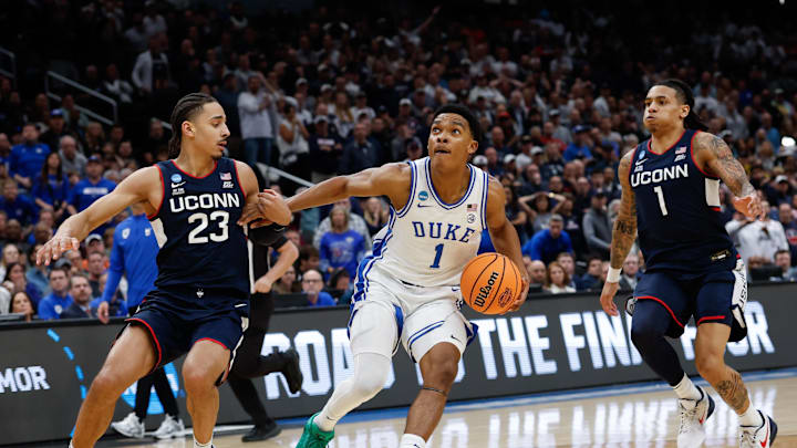 Mar 29, 2026; Washington, DC, USA; Duke Blue Devils guard Caleb Foster (1) goes to the basket against UConn Huskies forward Jayden Ross (23) in the second half during an Elite Eight game of the East Regional of the men's 2026 NCAA Tournament at Capital One Arena. Mandatory Credit: Geoff Burke-Imagn Images