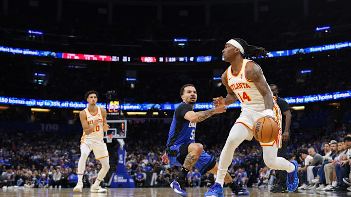 Apr 15, 2025; Orlando, Florida, USA; Atlanta Hawks guard Terance Mann (14) controls the ball against the Orlando Magic in the second quarter at Kia Center. Mandatory Credit: Nathan Ray Seebeck-Imagn Images