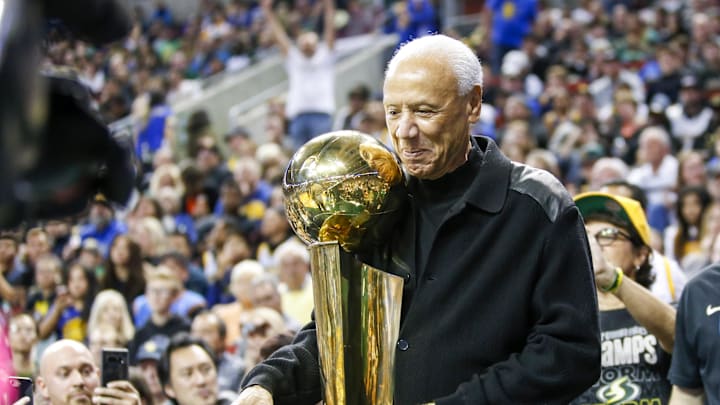 Oct 5, 2018; Seattle, WA, USA; Former Seattle Supersonics head coach Lenny Wilkens holds the 1979 championship trophy during a third quarter timeout of a game between the Sacramento Kings and Golden State Warriors at KeyArena. Mandatory Credit: Joe Nicholson-Imagn Images Oct 5, 2018; Seattle, WA, USA; Former Seattle Supersonics head coach Lenny Wilkens holds the 1979 championship trophy during a third quarter timeout of a game between the Sacramento Kings and Golden State Warriors at KeyArena. Mandatory Credit: Joe Nicholson-Imagn Images